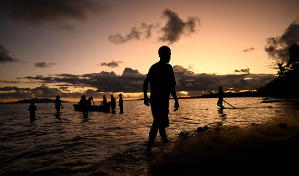 People fish as the sun sets in Toguru, Fiji. Fishing communities across the Pacific have expressed concern over Japan’s plan to release treated wastewater from the Fukushima plant. Photograph: Saeed Khan/AFP/Getty Images